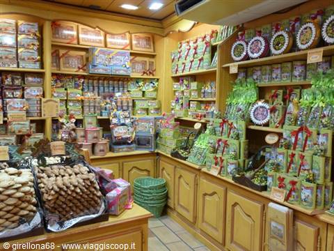 Wooden shelves filled with packaged sweets and biscuits in a shop
