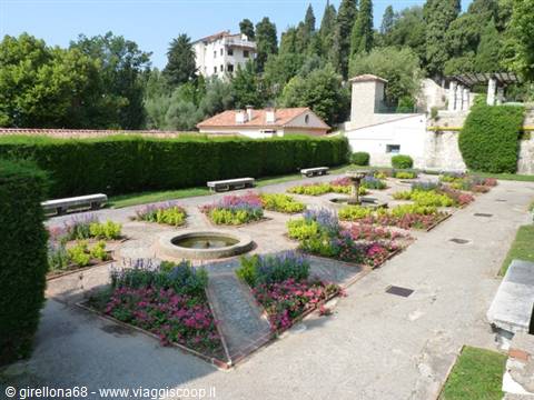geometric flowerbeds with colorful blooms in the terraced gardens of Miramare Castle