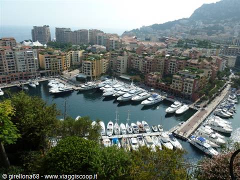 Fontvieille harbor in Monaco with yachts moored and colorful buildings