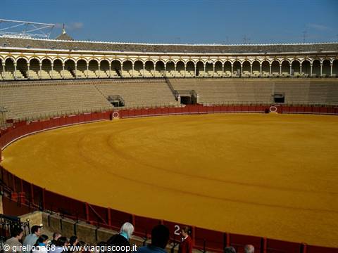 Ring of Seville's Real Maestranza bullring with yellow sand and empty stands