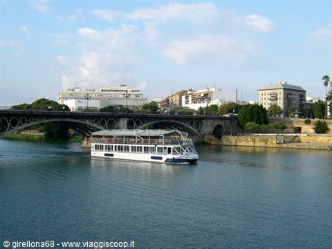 White sightseeing boat on the Guadalquivir under Triana bridge, Seville