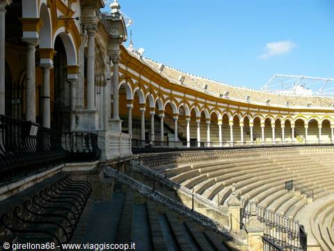 Seville's Plaza de Toros de la Real Maestranza, stone tiers and yellow arches