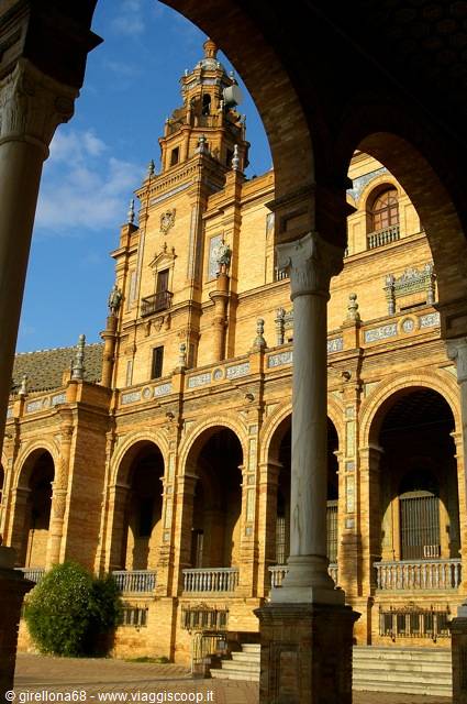Seville's Plaza de España: brick arches and marble columns frame the tower