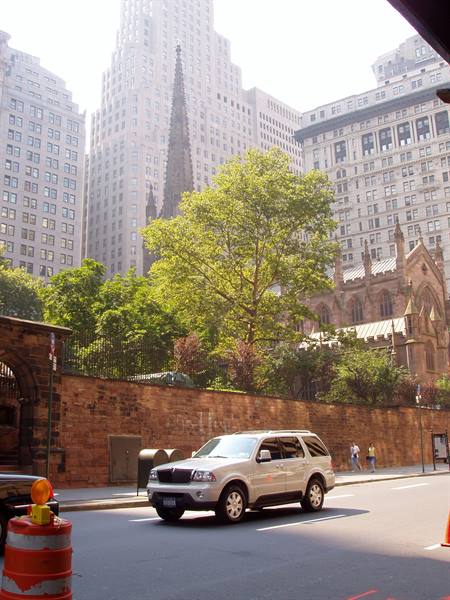 Gray SUV on street beside Trinity Church in New York
