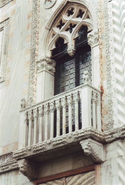 Gothic marble balcony with columns on a Venetian facade