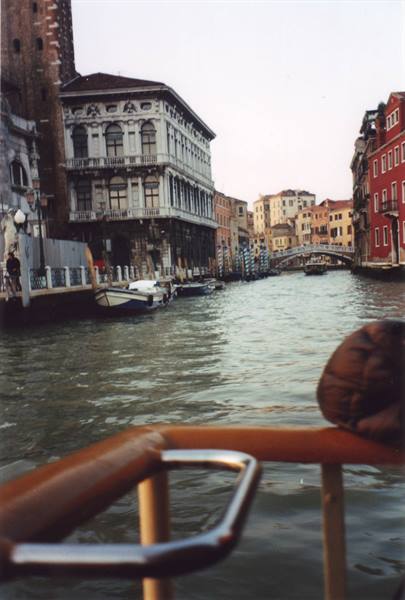 Venice canal seen from the vaporetto, old palaces and a bridge