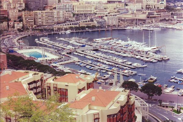 Yachts moored at Port Hercule, Monaco, with terracotta rooftops in foreground