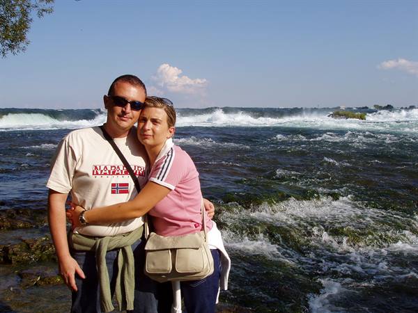 Couple hugging on the rocks at Niagara Falls rapids
