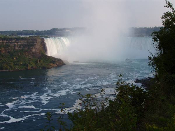 Niagara Falls' horseshoe cascade raises mist above the river