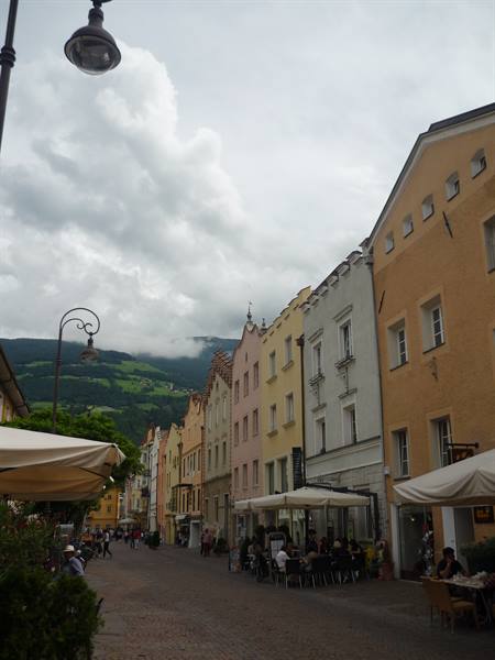 Brixen: colorful old-town buildings above a pedestrian street with café awnings