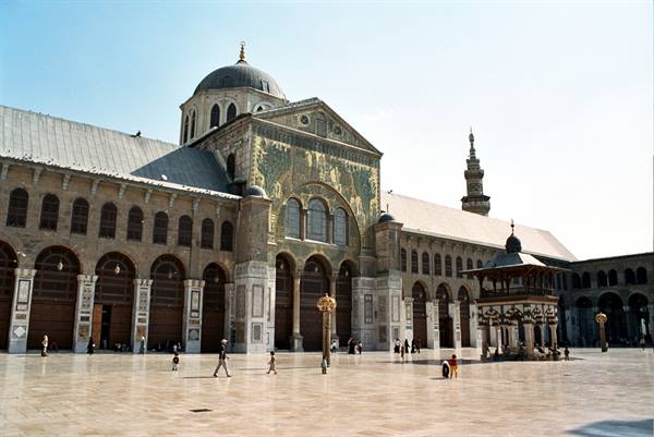 Marble courtyard of the Umayyad Mosque in Damascus with visitors