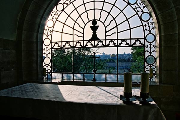 Altar with two candles before the Dominus Flevit church window, Jerusalem