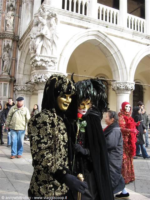 Carnival masks in costume in the courtyard of Doge's Palace, Venice