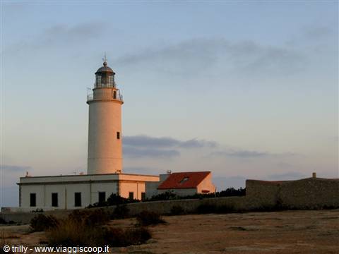 Capo Testa lighthouse, white walls among rocks and Mediterranean scrub