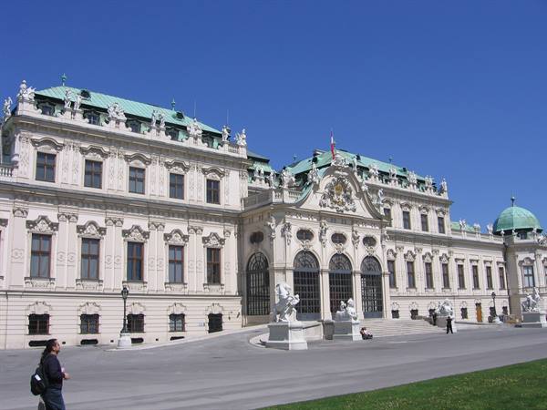 Baroque facade of Belvedere in Vienna, green roof, white statues, blue sky