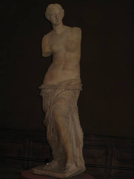The Venus de Milo at the Louvre, armless marble statue softly lit