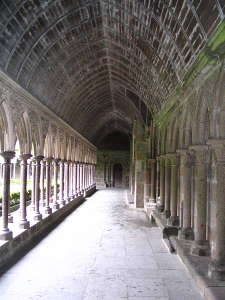 Gothic cloister of Mont-Saint-Michel abbey, granite columns and wooden vaulted ceiling