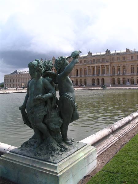 Bronze statue of children in front of the Palace of Versailles fountain