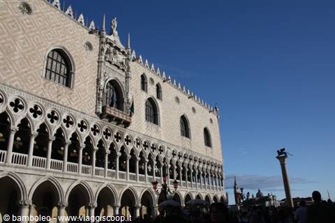 Doge's Palace in Venice, pink and white marble facade, Gothic arcades under blue sky
