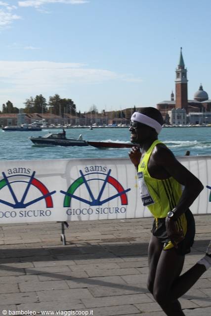 Runner racing past the lagoon, San Giorgio Maggiore in the background, Venice