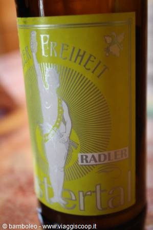 Freistädter Radler beer bottle with yellow label, torch-bearing woman