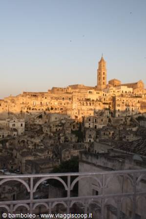 Golden morning light over the stone Sassi of Matera, cathedral on the hill