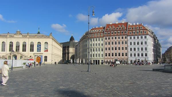Cobblestone square with restored baroque buildings and strolling pedestrians, Dresden