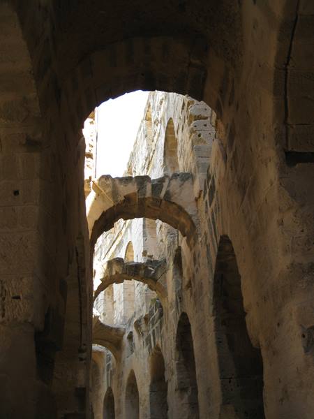 Stone arches of the Roman amphitheatre of Arles in daylight