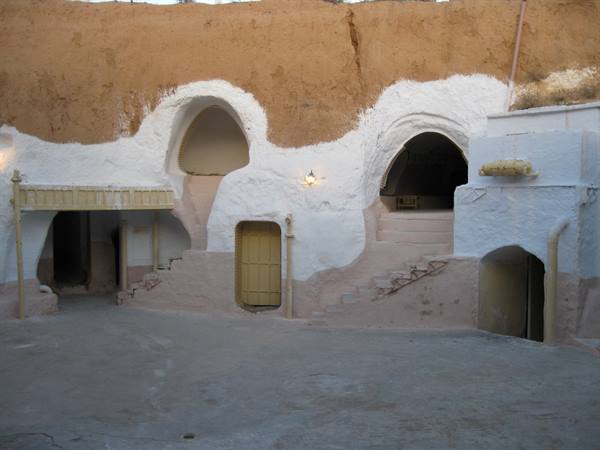 Whitewashed troglodyte cave dwellings in Matmata, carved sandstone courtyard