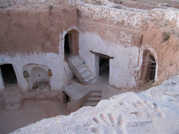 Troglodyte cave dwellings at Matmata, whitewashed earthen courtyard with carved rooms