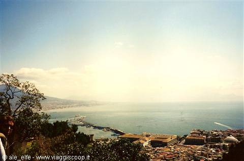 Naples bay with Mount Vesuvius, harbor and rooftops under hazy daylight