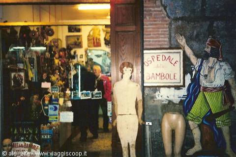 Doll hospital sign with old mannequins and painted pirate on brick wall