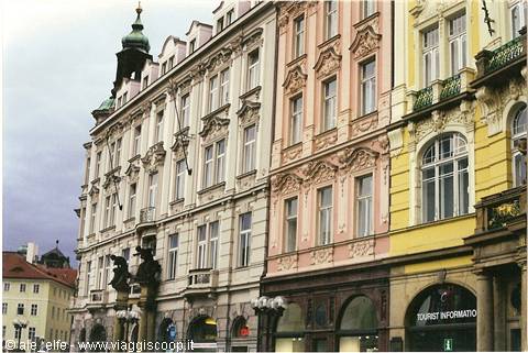 Pink and yellow baroque facades with stucco decorations on a Prague square
