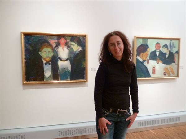 Visitor next to two Edvard Munch paintings at the Munch Museum, Oslo