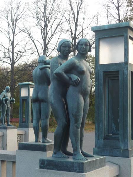 Bronze statues of women at Vigeland Park in Oslo, beside stone lanterns