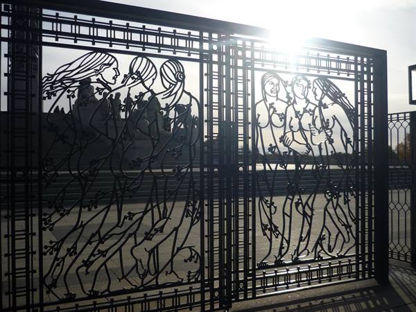 Wrought iron gate with female figures, Vigeland Park, Oslo, backlit sun