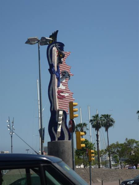 Lichtenstein's Cap de Barcelona sculpture, red and blue mosaic, traffic lights and palms