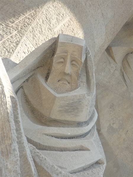 Stone sculpture of a veiled face on the Sagrada Família facade