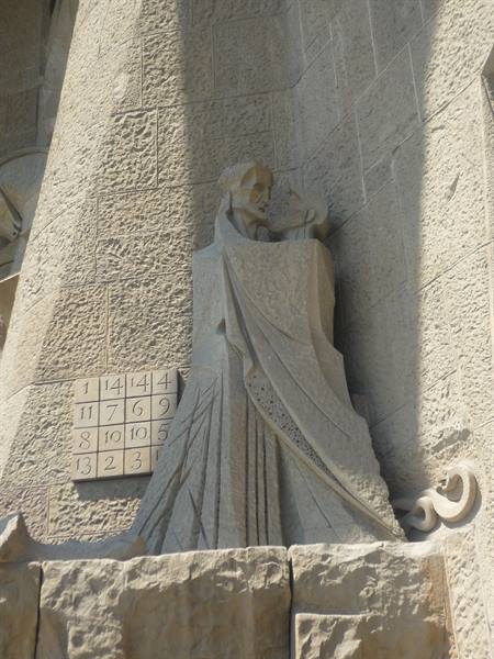 Stone statue beside magic square on Sagrada Família facade, Barcelona
