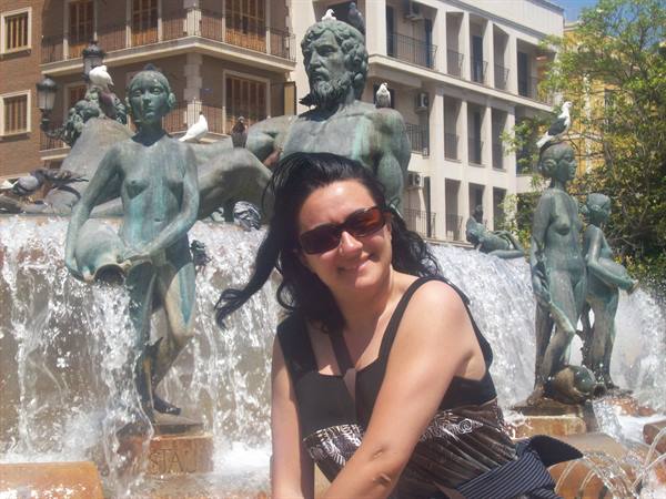 Woman in sunglasses before the Turia fountain in Valencia