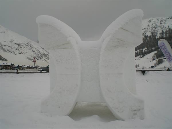 Butterfly-shaped snow sculpture in a snowy mountain village