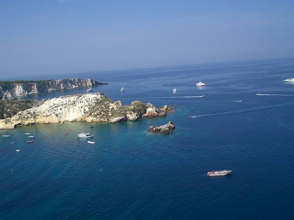 White limestone cliffs and boats in turquoise Tremiti waters