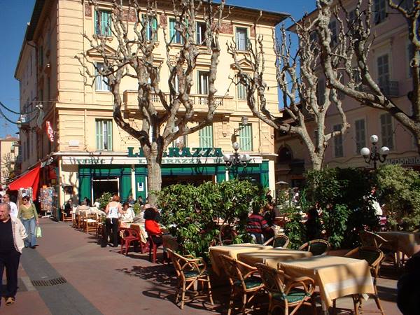 Outdoor café tables outside La Terrazza among leafless plane trees