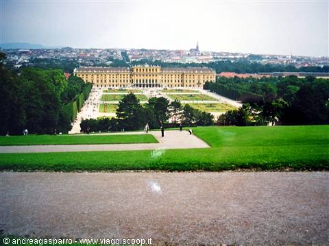 Schönbrunn Palace with its green gardens under a cloudy sky