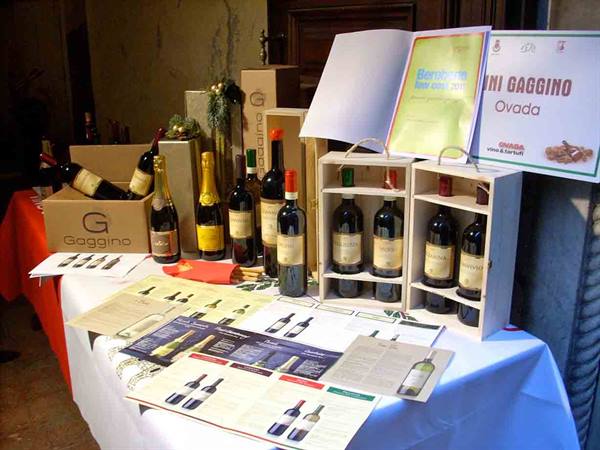 Gaggino Ovada wine bottles in wooden crates on display table