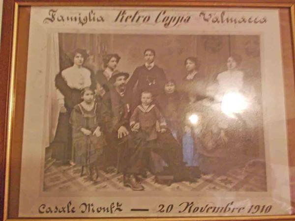 Framed vintage family portrait posed in studio, dated 1910