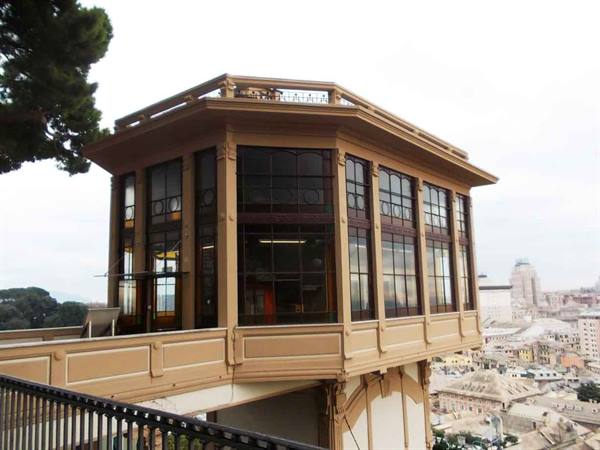 Octagonal wooden and glass lift station pavilion above the city rooftops