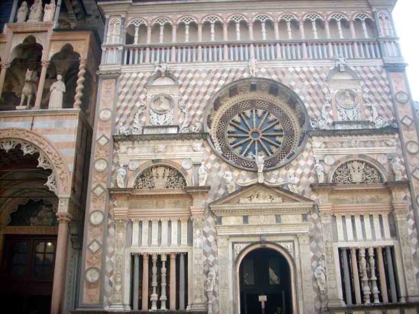 Marble facade with rose window of the Colleoni Chapel in Bergamo