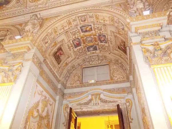 Frescoed vaulted ceiling above an inner doorway of a baroque palace