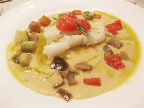 Cod fillet on chickpea cream with vegetables, cherry tomatoes and rosemary
